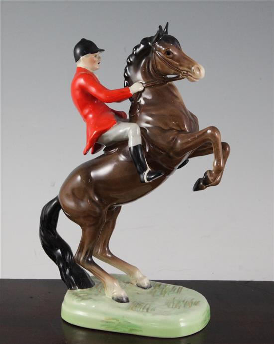 A Beswick pottery group of a huntsman on a rearing horse, model no.868, 14.5cm